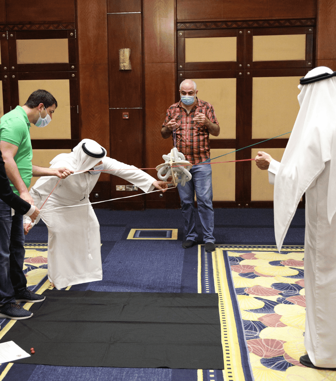 diverse gcc team engaging in a interactive teambuilding event with biz group to boost collaboration and productivity