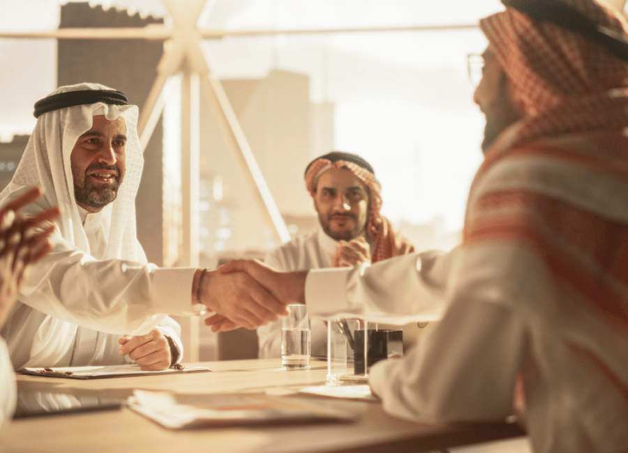 saudi men shaking hands after a successful corporate sales deal biz group