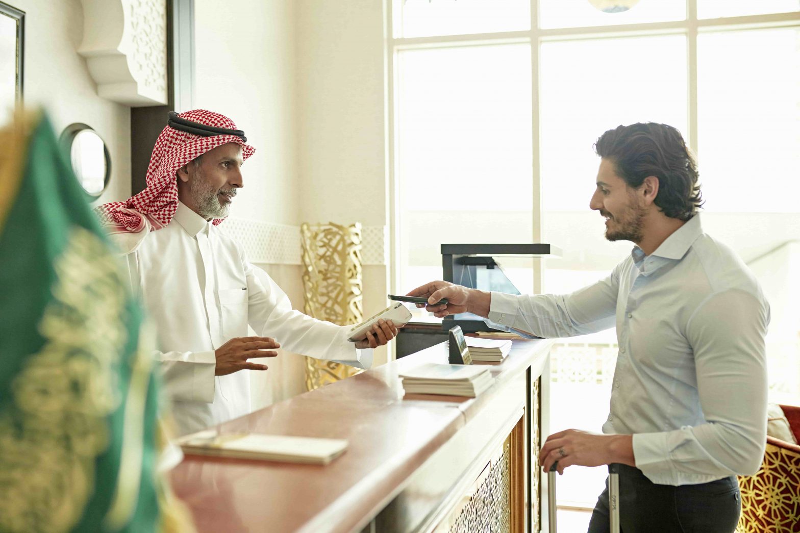 KSA hospitality worker interacting with a customer after being empowered by training